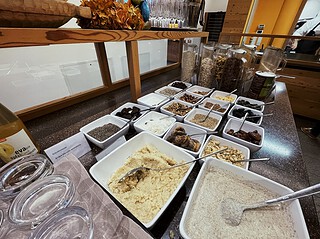 Veganer Fr&uuml;hst&uuml;ckstisch mit Hafer, N&uuml;ssen, Samen und Toppings.