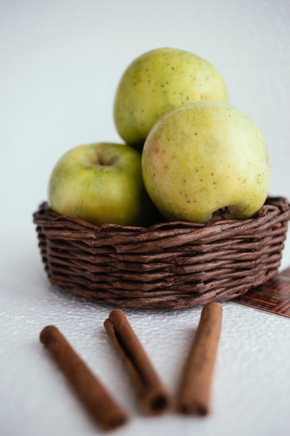 Green apples and cinnamon sticks on display