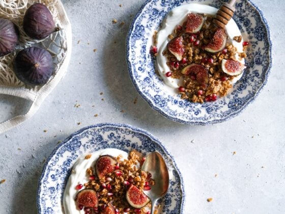 Two bowls of soy yogurt topped with fruits