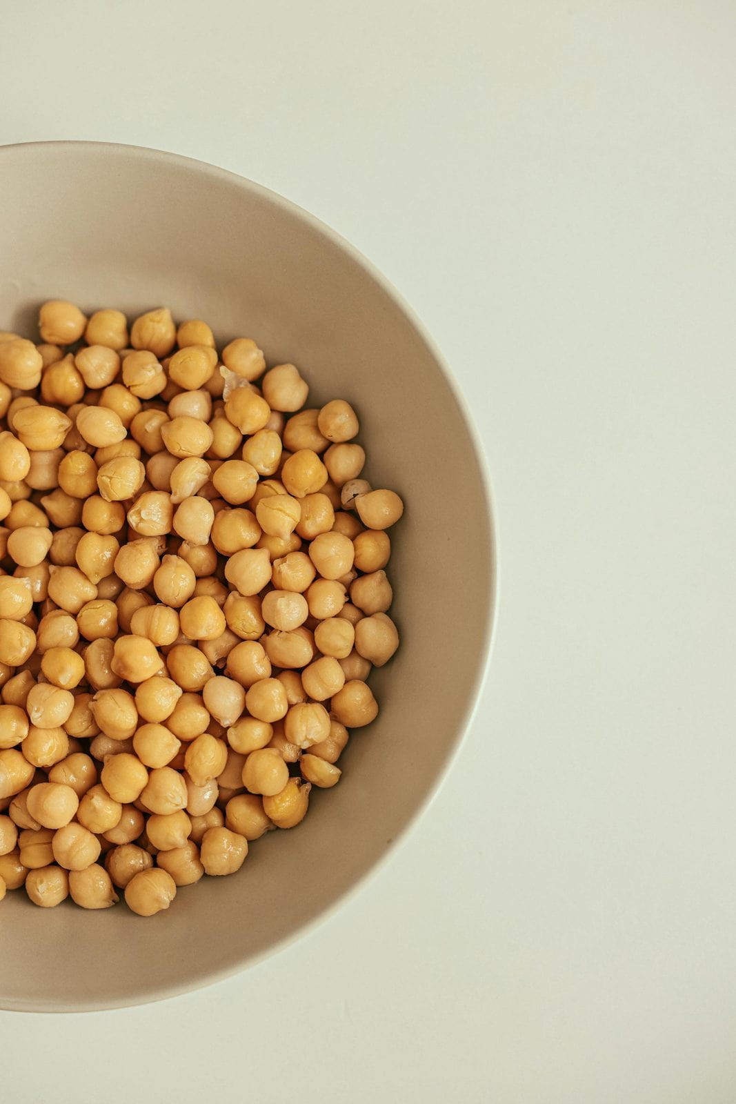 Vegane Mayonnaise wird über einen Salat geträufelt, klassische Anwendung