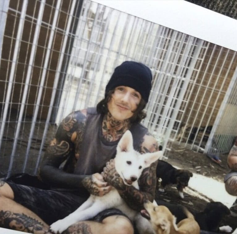Oli Sykes of Bring Me The Horizon with his dog Luna as a puppy at an animal shelter