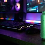 Ist Monster Energy vegan? Der große Sorten-Check Grün leuchtende Energy-Drink-Dose mit Kondenswasser auf einem Schreibtisch vor einem Gaming-Setup