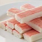 Is Imitation Crab Vegan? No, and It's Not Even Vegetarian Sticks of imitation crab meat arranged on a plate