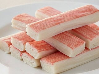 Sticks of imitation crab meat arranged on a plate