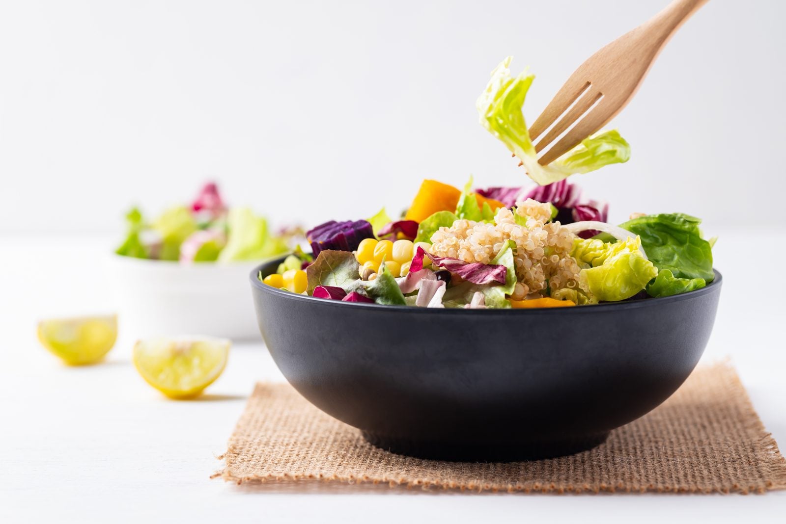 A colourful vegan salad bowl with quinoa, corn and mixed leaves