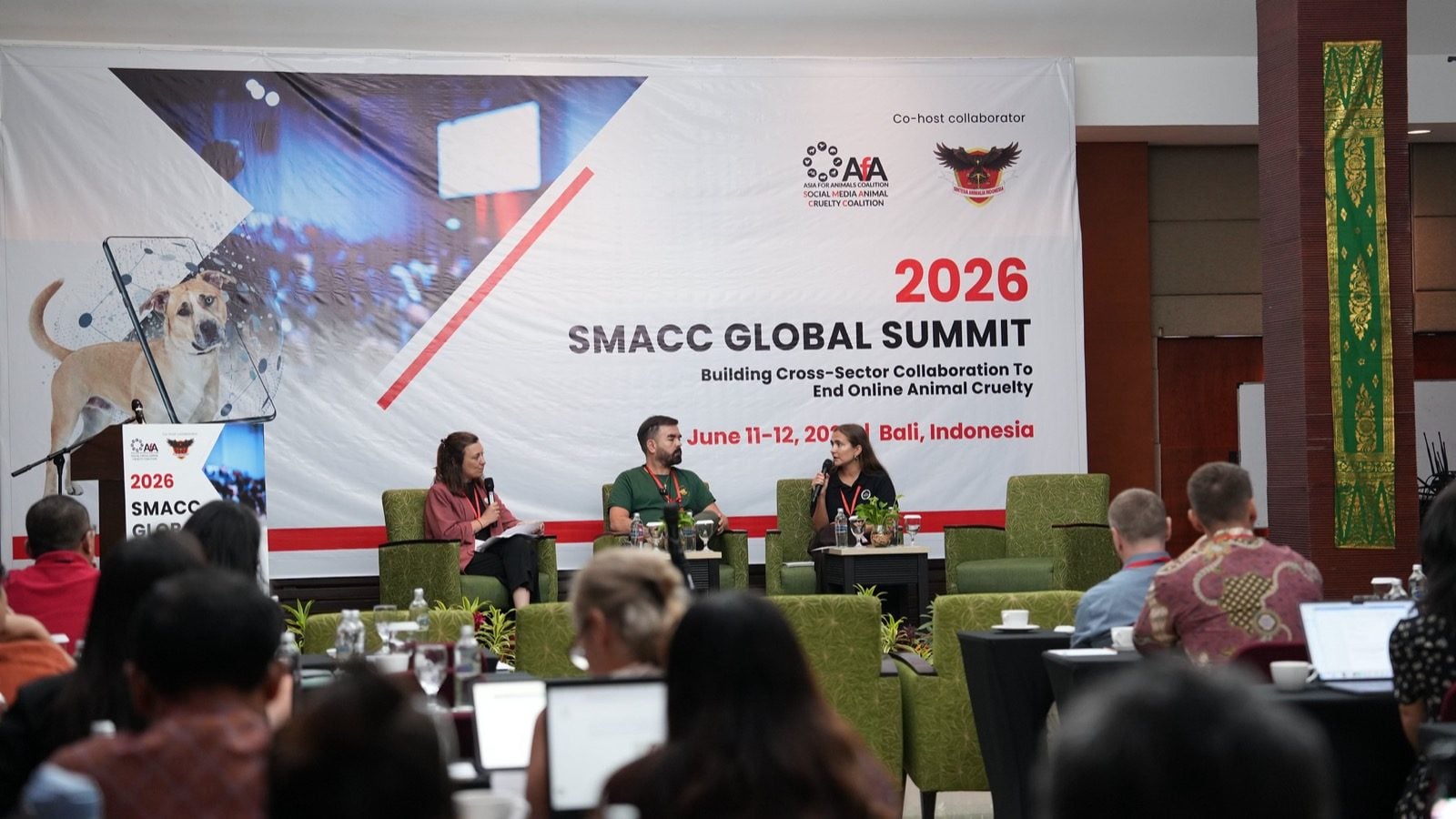 Panel at the SMACC Global Summit 2026 in Bali in front of the summit banner