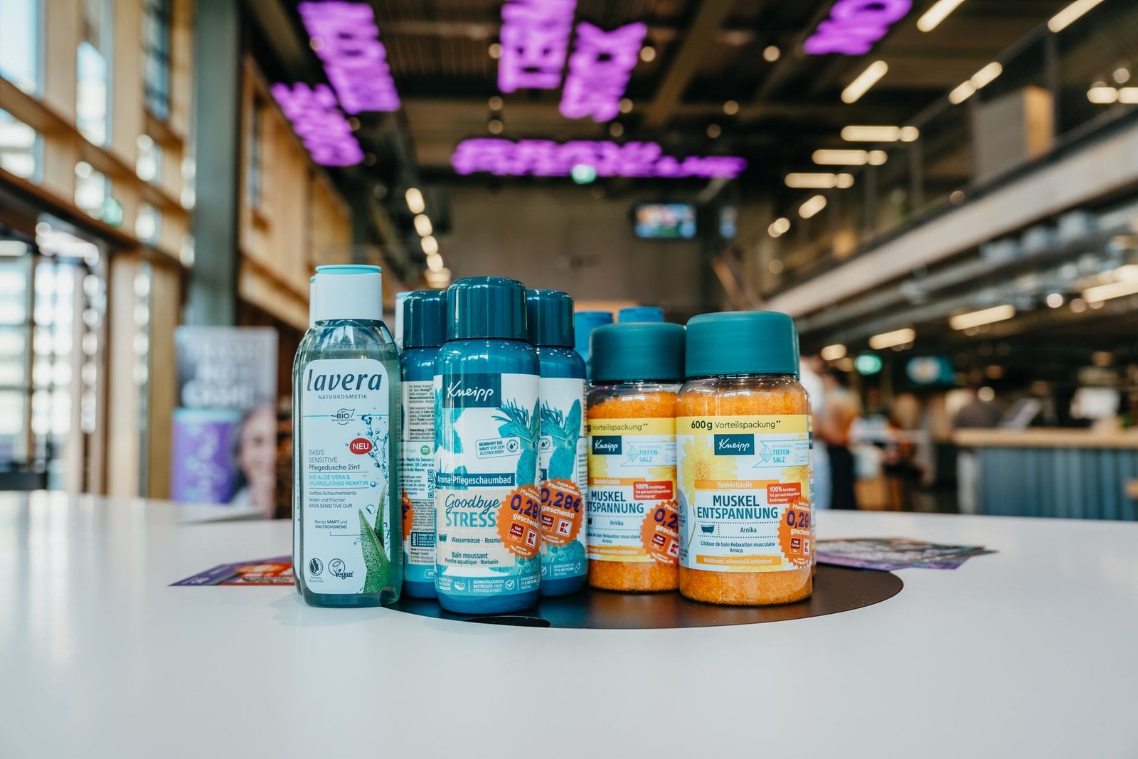 lavera and Kneipp products on a table at the reo kick-off, the Gravity hall in Heilbronn in the background