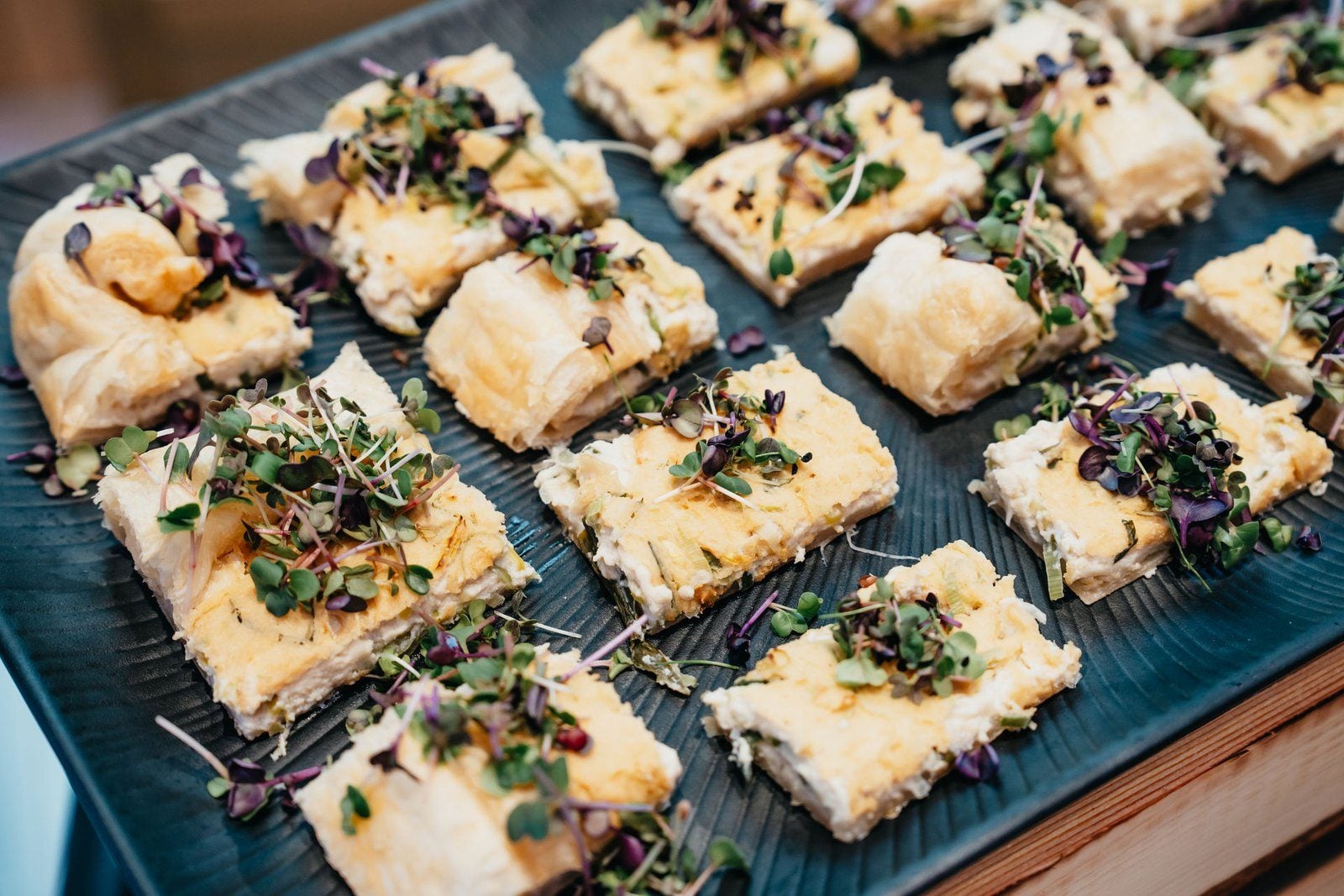 Vegan canapés on a slate board, garnished with herbs and microgreens, from the catering at the kick-off