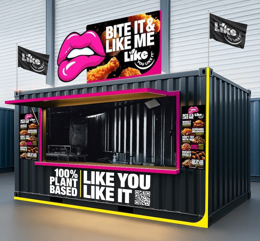 Visualisierung eines schwarzen Imbiss-Containers mit pinkem Lippen-Logo und der Aufschrift 100% Plant Based, Like you like it