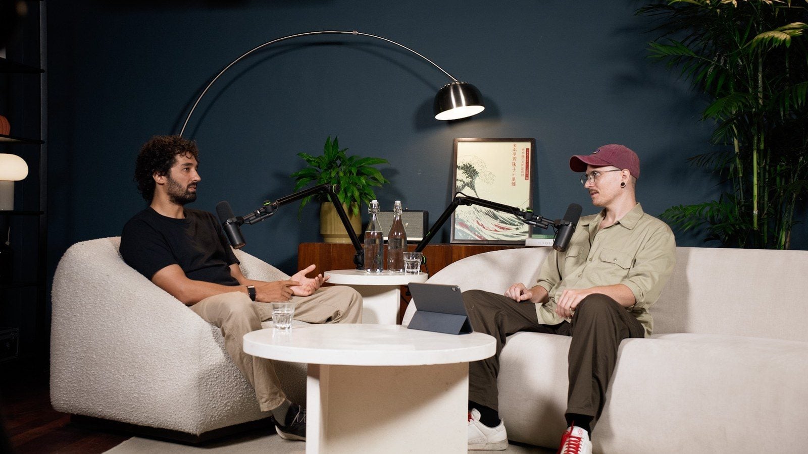 Seb Alex and Yannick Haldenwanger sitting with microphones in the studio, talking