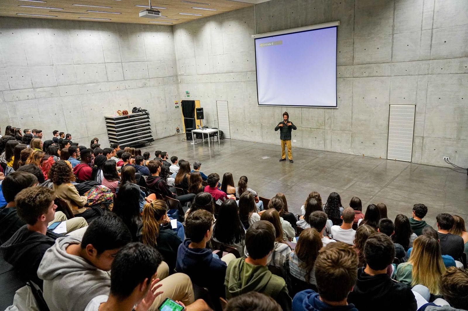Seb Alex speaking in front of a large audience at an animal rights event