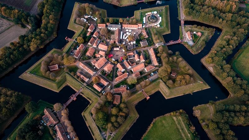 Landschaft in Westerwolde: Luftbild des sternförmigen Festungsdorfs Bourtange mit Wassergräben und Wäldern