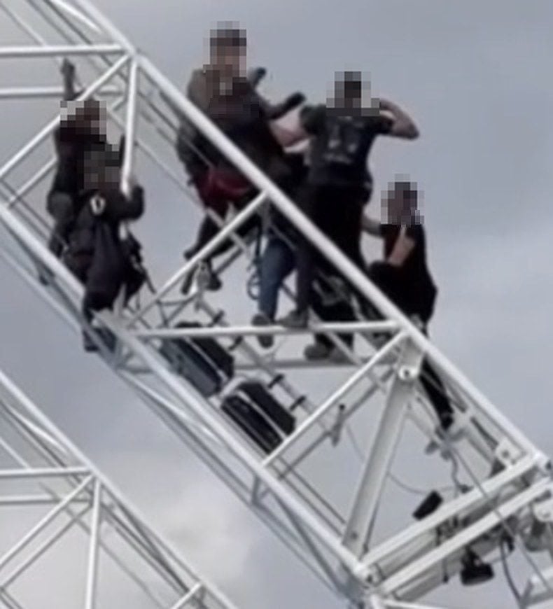 Closer crop of the same footage, one person with a raised, bent arm