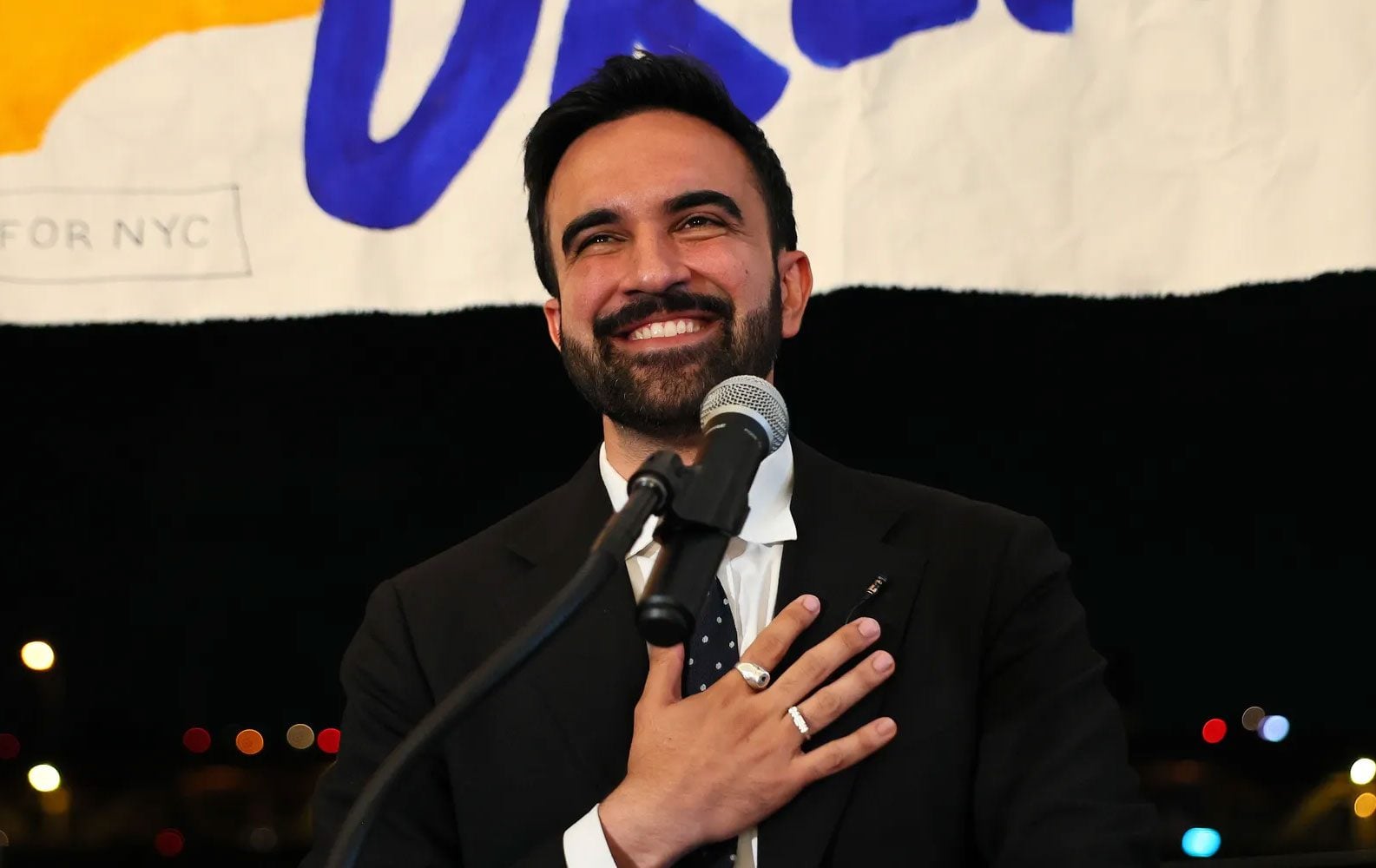 Zohran Mamdani, Mayor of New York City, speaking at a microphone